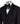 Front view of a black hand-embellished tuxedo with intricate beadwork and sequin patterns, displayed on a mannequin. Features a single-breasted jacket, peak lapel, matching vest, and trousers, embodying luxury bespoke craftsmanship from Istanbul.