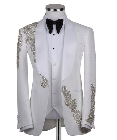White hand-embellished jacquard three-piece tuxedo with crystal detailing on jacket and white satin shawl lapel. Master tailored in Istanbul for luxury events and weddings.