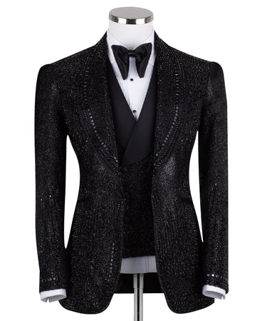 Front view of a black hand-embellished three-piece tuxedo by BTS Bespoke, featuring a single-breasted jacket with satin shawl lapels and a double-breasted vest, showcased on a mannequin.