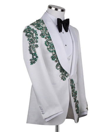 BTS Bespoke white three-piece tuxedo with intricate emerald green hand-embellished details on the jacket, shoulders, and sleeves. Features a white shawl lapel and vest. Front view and side view of the luxury suit on a mannequin.