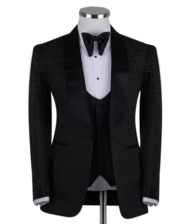 Black hand-embellished three-piece tuxedo by BTS Bespoke, featuring an intricate beaded pattern on the shoulders and back, satin shawl lapel, and matching vest and trousers. Masterfully crafted in Istanbul for luxury events.
