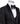Black slim fit hand-embellished tuxedo on a mannequin, featuring a satin peak lapel, matching vest, and intricate black beadwork detailing on the shoulder, lapel, and sleeves. The tuxedo fabric has a subtle jacquard texture, showcasing master tailoring from Istanbul.