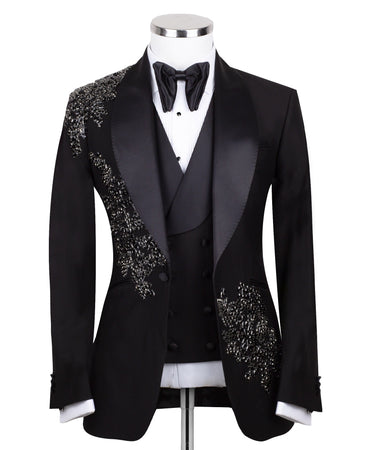 BTS Bespoke Black Embellished Three-Piece Tuxedo. Handcrafted single-breasted jacket with peak lapel and shimmering crystal embellishments. Includes matching double-breasted vest and trousers.