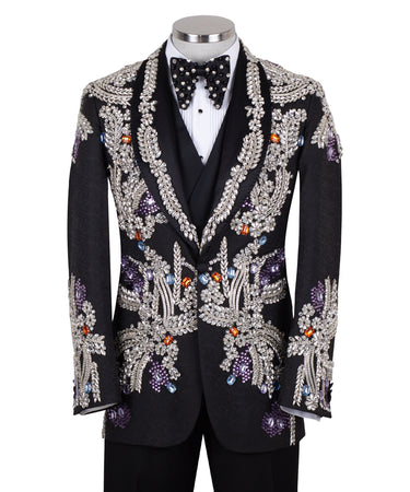 Front and side view of a black tuxedo jacket with extensive silver, purple, orange, and blue crystal and gemstone embellishments in floral and baroque patterns, paired with matching black trousers and vest, on a mannequin. Showcases intricate hand-embellished details and luxurious craftsmanship from BTS Bespoke, Istanbul.