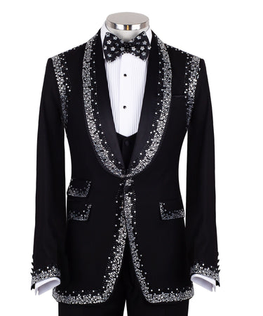 BTS Bespoke Black Embellished Shawl Lapel Tuxedo, featuring shimmering silver crystals hand-embellished on lapels, shoulders, pockets, and cuffs. The tuxedo includes a black single-breasted jacket, matching vest, and trousers, displayed on a mannequin. This luxury evening wear is handcrafted in Istanbul, showcasing master tailoring and intricate crystal detailing for a glamorous, statement look.