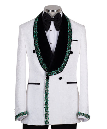 White double-breasted tuxedo jacket with textured fabric, black velvet shawl lapel, emerald green hand-embellished jewels, black buttons, and matching black trousers. Luxurious, handcrafted in Istanbul by BTS Bespoke.