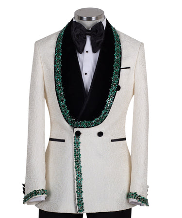 BTS Bespoke Cream textured double-breasted tuxedo with black velvet shawl lapel and emerald green hand-embellishments on jacket front, lapel, and cuffs, paired with black trousers.
