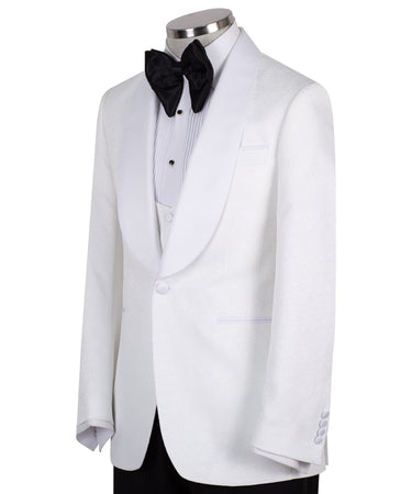 Front view of a white jacquard patterned single-breasted tuxedo jacket with a white satin shawl lapel, displayed on a mannequin. Includes a matching white jacquard vest and black trousers. Handmade in Istanbul luxury bespoke menswear.
