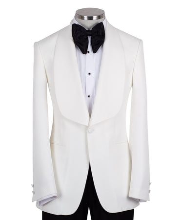 White textured shawl lapel tuxedo jacket and black trousers by BTS Bespoke, handcrafted in Istanbul. View shows single-button closure and elegant detailing.
