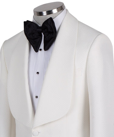 White textured shawl lapel tuxedo jacket and black trousers by BTS Bespoke, handcrafted in Istanbul. View shows single-button closure and elegant detailing.