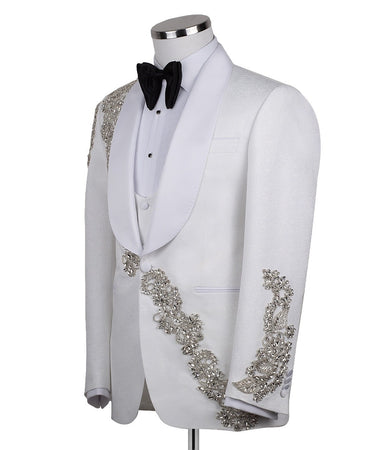 White hand-embellished jacquard three-piece tuxedo with crystal detailing on jacket and white satin shawl lapel. Master tailored in Istanbul for luxury events and weddings.