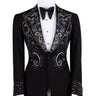 Black embellished three-piece tuxedo with intricate crystal and bead patterns on satin peak lapels, chest, and cuffs. Features a matching vest. Handcrafted luxury suit from BTS Bespoke Istanbul.