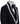 Full front view of a black three-piece tuxedo on a mannequin, featuring heavily hand-embellished shawl lapels with pearls and crystals, and a matching embellishment down the side of the trousers. Includes a black double-breasted vest and a white shirt with a black bow tie (not included).