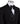 Close-up of a black double-breasted tuxedo jacket on a mannequin, showcasing intricate hand-embellishments with beads and crystals on the lapels and body. Features a peak lapel and black buttons, paired with a white shirt and black bow tie. Front view showing the full jacket and details.