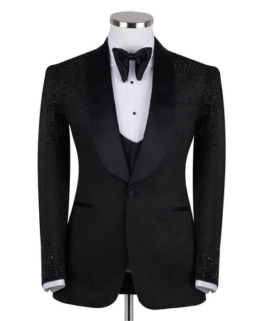 Black hand-embellished three-piece tuxedo by BTS Bespoke, featuring an intricate beaded pattern on the shoulders and back, satin shawl lapel, and matching vest and trousers. Masterfully crafted in Istanbul for luxury events.