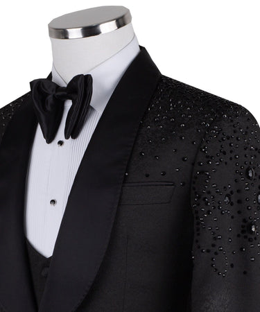 Black hand-embellished three-piece tuxedo by BTS Bespoke, featuring an intricate beaded pattern on the shoulders and back, satin shawl lapel, and matching vest and trousers. Masterfully crafted in Istanbul for luxury events.