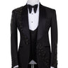 Black slim fit hand-embellished tuxedo on a mannequin, featuring a satin peak lapel, matching vest, and intricate black beadwork detailing on the shoulder, lapel, and sleeves. The tuxedo fabric has a subtle jacquard texture, showcasing master tailoring from Istanbul.
