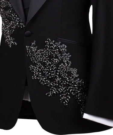 BTS Bespoke Black Embellished Three-Piece Tuxedo. Handcrafted single-breasted jacket with peak lapel and shimmering crystal embellishments. Includes matching double-breasted vest and trousers.