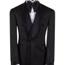 Front view of a black textured double-breasted tuxedo with hand-embellished shawl lapels, cuffs, and front trim. The trousers have a satin side stripe. High-end luxury formal wear from BTS Bespoke.