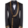 Mannequin wearing a black double-breasted tuxedo with ornate gold beaded peak lapels and matching cuff embellishments, paired with black satin-striped trousers.