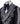 Front view of a black double-breasted tuxedo jacket with extensive silver embellishments, featuring a peak lapel and slim fit design on a mannequin. Back view and close-up showing intricate hand-beading detail.