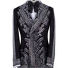 Front view of a black double-breasted tuxedo jacket with extensive silver embellishments, featuring a peak lapel and slim fit design on a mannequin. Back view and close-up showing intricate hand-beading detail.