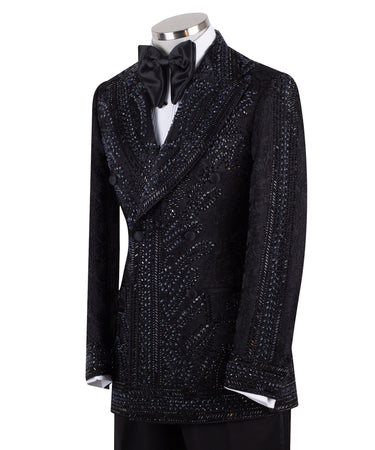 Front view of a luxurious black embellished jacquard double-breasted tuxedo jacket with intricate sequin and bead work on lapels, body, and sleeves, paired with black trousers, worn on a mannequin. From BTS Bespoke, handcrafted in Istanbul.
