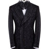 Front view of a luxurious black embellished jacquard double-breasted tuxedo jacket with intricate sequin and bead work on lapels, body, and sleeves, paired with black trousers, worn on a mannequin. From BTS Bespoke, handcrafted in Istanbul.