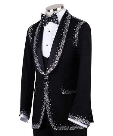 BTS Bespoke Black Embellished Shawl Lapel Tuxedo, featuring shimmering silver crystals hand-embellished on lapels, shoulders, pockets, and cuffs. The tuxedo includes a black single-breasted jacket, matching vest, and trousers, displayed on a mannequin. This luxury evening wear is handcrafted in Istanbul, showcasing master tailoring and intricate crystal detailing for a glamorous, statement look.