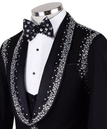 BTS Bespoke Black Embellished Shawl Lapel Tuxedo, featuring shimmering silver crystals hand-embellished on lapels, shoulders, pockets, and cuffs. The tuxedo includes a black single-breasted jacket, matching vest, and trousers, displayed on a mannequin. This luxury evening wear is handcrafted in Istanbul, showcasing master tailoring and intricate crystal detailing for a glamorous, statement look.