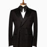 Front view of a black double-breasted tuxedo jacket featuring intricate hand-embellished studs on the peak lapels, shoulders, sleeves, and lower body, styled with matching black trousers with a satin side stripe. Handcrafted luxury from BTS Bespoke Istanbul.