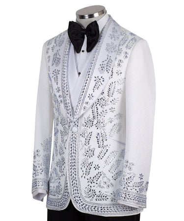 Front view of a white heavily embellished three-piece tuxedo with silver sequins and beadwork, featuring a shawl lapel and a matching white vest, displayed on a mannequin. Handmade in Istanbul.