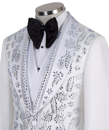 Front view of a white heavily embellished three-piece tuxedo with silver sequins and beadwork, featuring a shawl lapel and a matching white vest, displayed on a mannequin. Handmade in Istanbul.