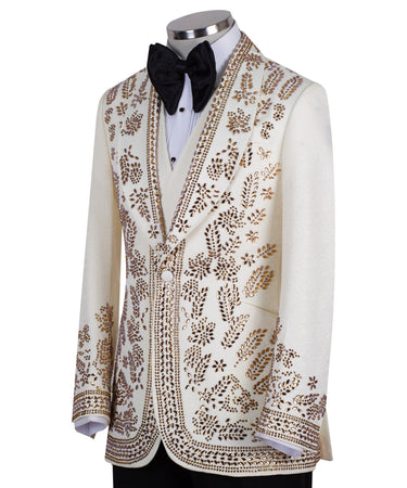 Cream and gold hand-embellished tuxedo jacket, vest, and black trousers from BTS Bespoke, handcrafted in Istanbul. Features intricate floral metallic stud detailing on a slim-fit, peak lapel design.
