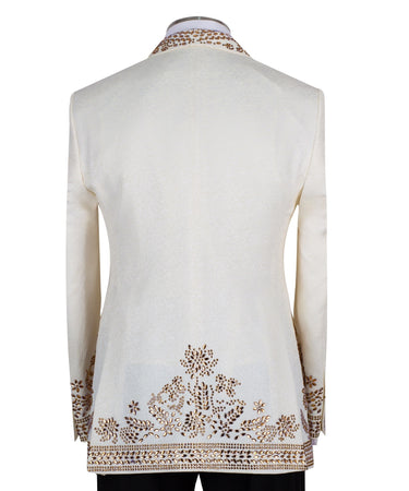 Cream and gold hand-embellished tuxedo jacket, vest, and black trousers from BTS Bespoke, handcrafted in Istanbul. Features intricate floral metallic stud detailing on a slim-fit, peak lapel design.