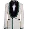 BTS Bespoke Cream textured double-breasted tuxedo with black velvet shawl lapel and emerald green hand-embellishments on jacket front, lapel, and cuffs, paired with black trousers.