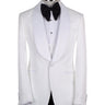 Front view of a white jacquard patterned single-breasted tuxedo jacket with a white satin shawl lapel, displayed on a mannequin. Includes a matching white jacquard vest and black trousers. Handmade in Istanbul luxury bespoke menswear.