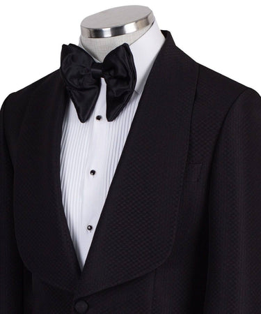 Black single-breasted tuxedo with subtle jacquard pattern and elegant shawl lapel, handcrafted in Istanbul by BTS Bespoke, front view on mannequin.